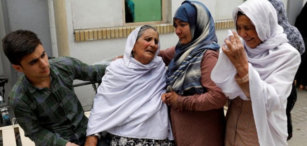Relatives of the victims mourn at a hospital after a suicide attack in Kabul. Photo: Reuters