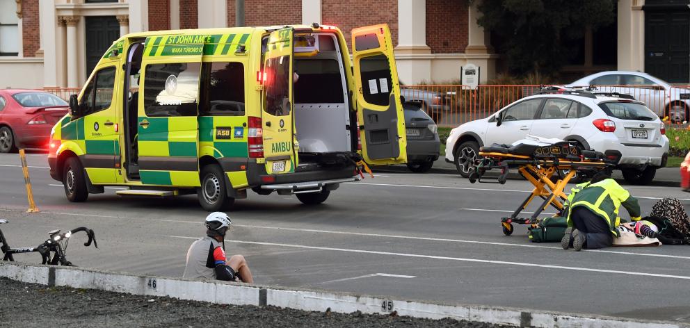 Emergency services attend to a cyclist who was hit by a car yesterday morning. PHOTO: STEPHEN...