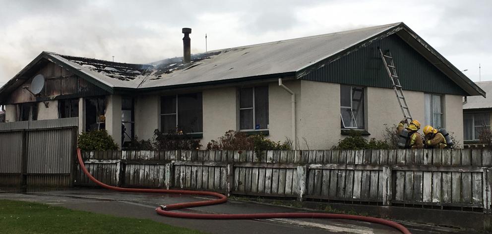 Three fire crews were called at 2.13pm to a blaze raging at a home in Centre St, near Glenalmond Cres, Invercargill. Photo: Sharon Reece
