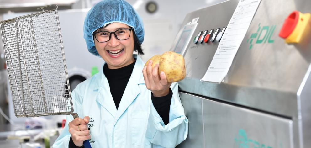 Professor Indrawati Oey of the Otago University Department of Food Sciences with the new PEF machine where potatoes go through and are made into chips. Photo: Peter McIntosh