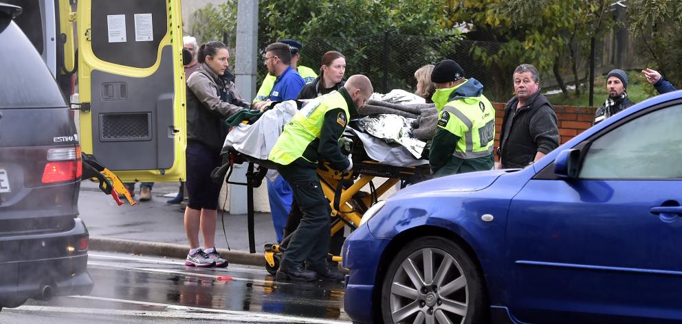 A Kaikorai Valley College pupil is helped to an ambulance after being hit by a truck yesterday...
