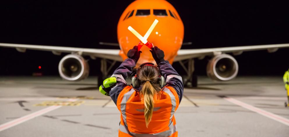 The first international flight to land at Queenstown Airport at night, a Jetstar Airbus A320, is...