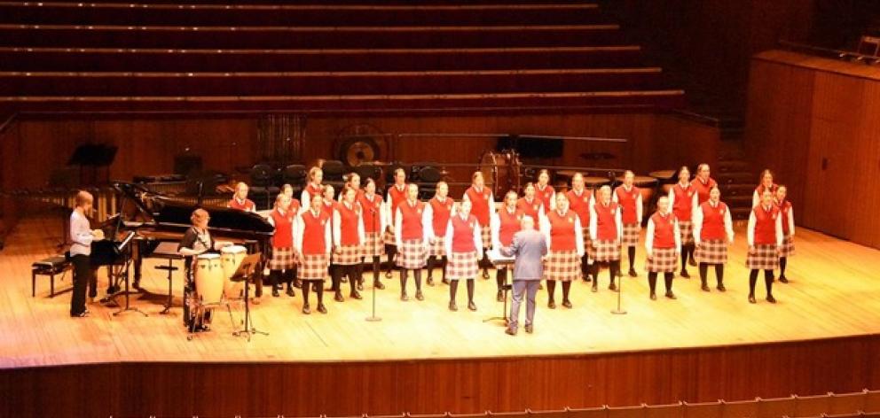 Conductor John Buchanan leads the Dunstanza Senior Girls' choir with accompanist Sharon McLennan ...