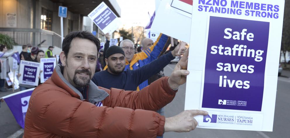 Dunedin nurse Craig Christensen makes his point during protests yesterday.