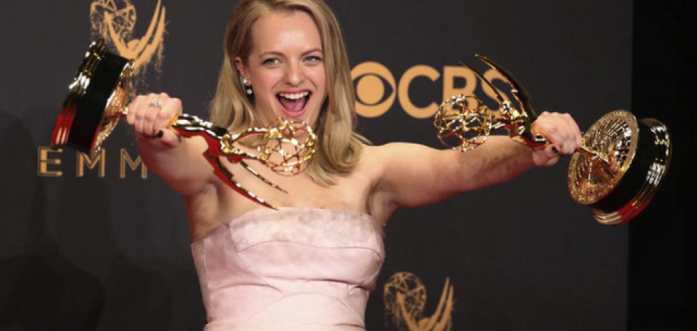 Elizabeth Moss poses backstage with her awards for Outstanding Lead Actress in a Drama Series and...