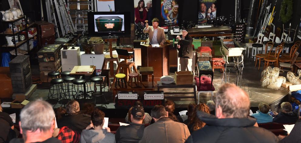Hayward Auction House owner John More  takes bids  for  Fortune Theatre items  on Saturday....