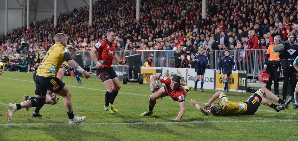 George Bridge of the Crusaders dives over to score a try. Photo: Getty Images