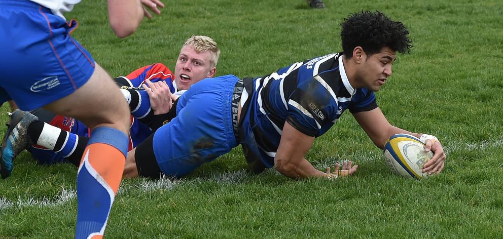 Kaikorai midfielder TeeJay Ane goes over for a try in the tackle of Harbour first five-eighth...