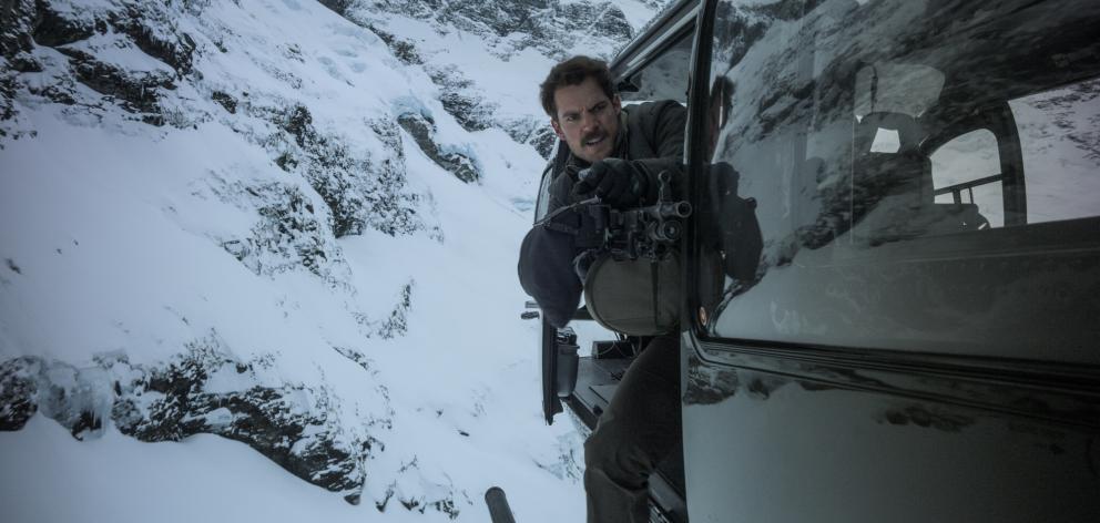 Henry Cavill in action during a helicopter chase sequence filmed in Queenstown last year as part...
