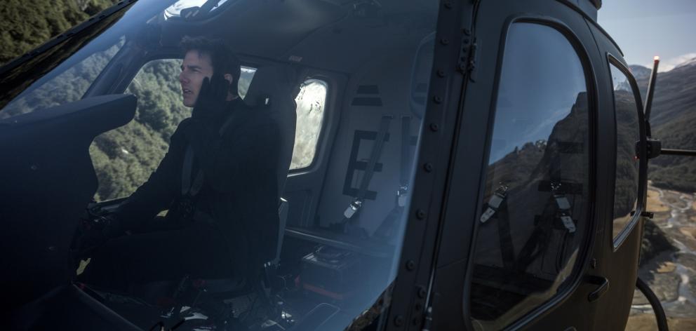 Tom Cruise flies a helicopter in Queenstown during filming last year.