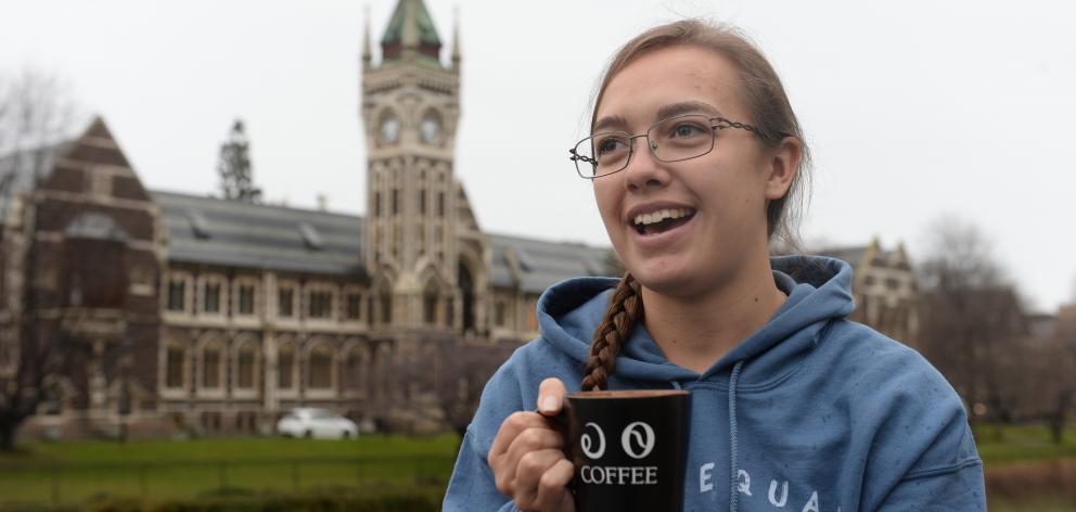 Miranda Livers, of California, enjoys a hot drink on the University of Otago campus from a cup...