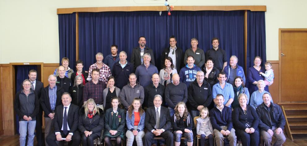 Acting Prime Minister Winston Peter (front centre), Regional Economic Development Minister Shane Jones (front far left) and New Zealand First MP Mark Patterson (second row second from left) celebrate with members of the Pourakino Catchment Group, after th