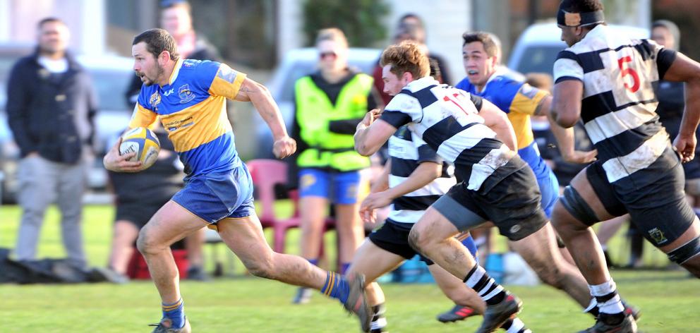 Taieri midfield back Kori Rupune heads for the tryline chased by Southern defenders (from left):...