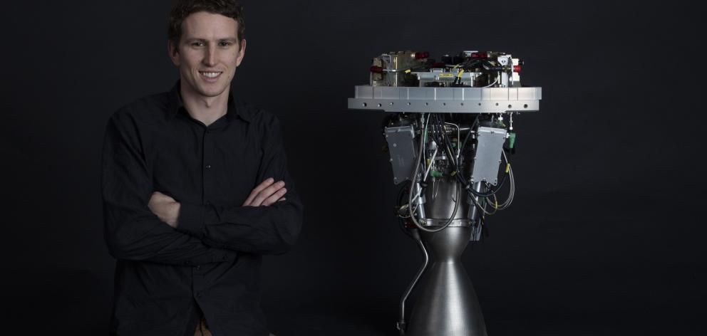 Lachlan Matchett with the engine he helped design for Rocket Lab's Electron rocket. Photo: Rocket...
