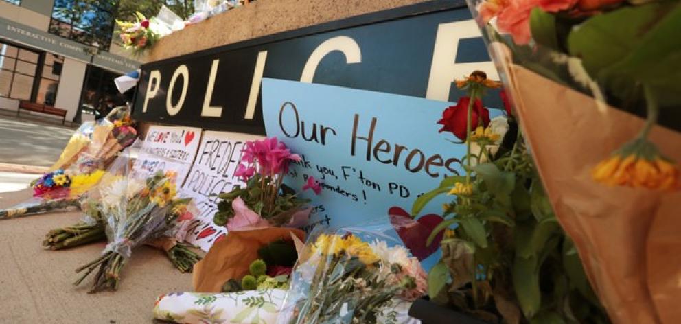 A makeshift memorial has been forming outside Fredericton Police Headquarters in Fredericto. Photo: Reuters