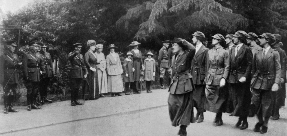 Women mechanical transport drivers marching past a royal party at Aldershot, comprising the King, Queen, Princess Mary and the Duke of Connaught. - Otago Witness, 14.8.1918.