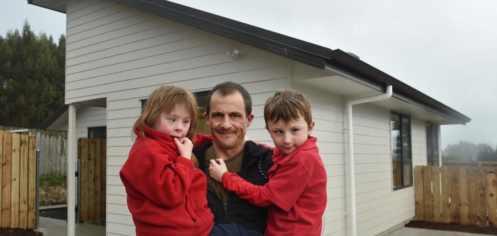 New state house tenants Brendan Selwood and children Emily (8, left) and Alex (6) arrive at their...