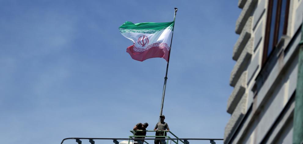 The flag of Iran flies on a rooftop. Photo: Reuters