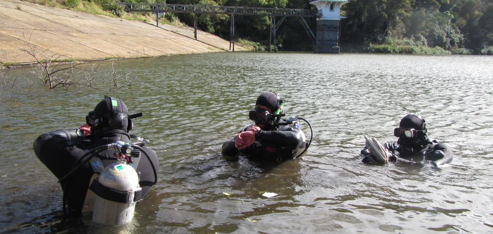 A police dive squad searches for clues about Tuitania Barclay’s disappearance at Ross Creek in...