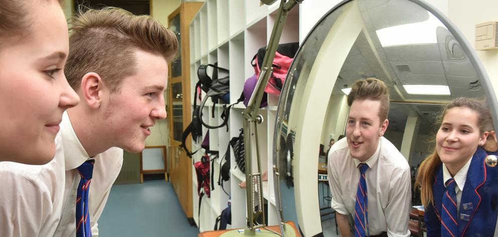 St Peter's College pupils Mia Walton (16) and Wyatt Simon (17) see how light behaves in a diverging mirror during the Otago University Advanced School Sciences Academy for rural schools yesterday. Photo: Gregor Richardson