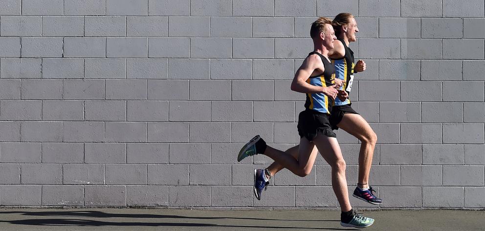 Hill City-University runners Jared Monk (nearest camera) and Jacob Priddey are locked in a tight...