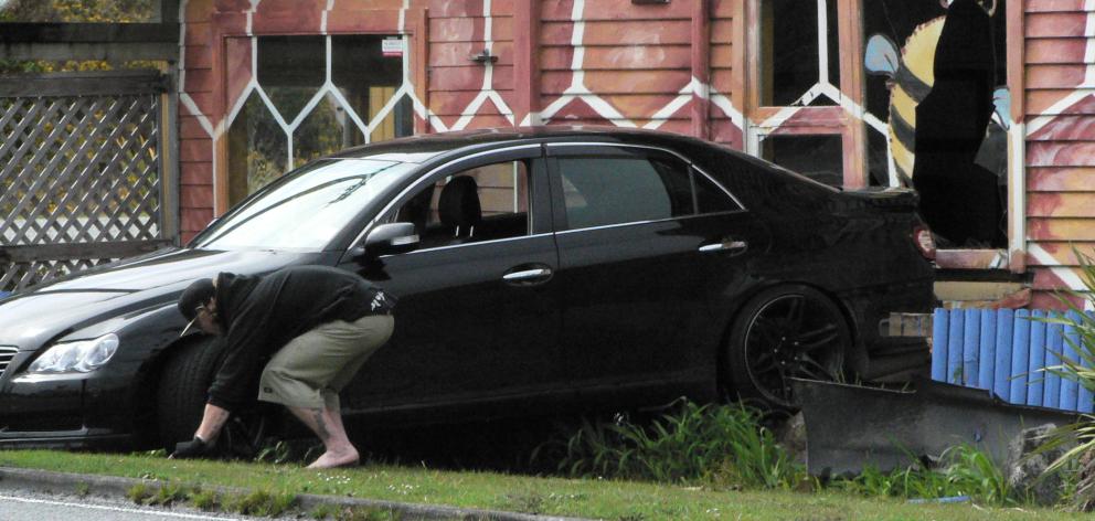 A driver lost control on a roundabout, causing the car to go backwards through the front window of a West Coast cafe. Photo: Greymouth Star