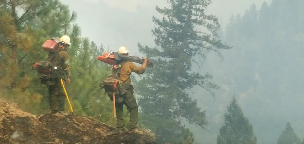 Firefighters at the Mendocino fire in Northern California take stock of where to create fire...