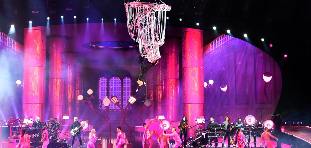 Pink makes a dramatic chandelier-swinging entrance to start her Dunedin show.