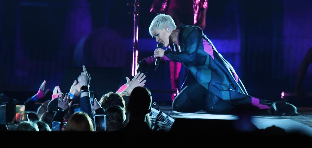 Pop star Pink reaches into an adoring crowd at Forsyth Barr Stadium for the first New Zealand...