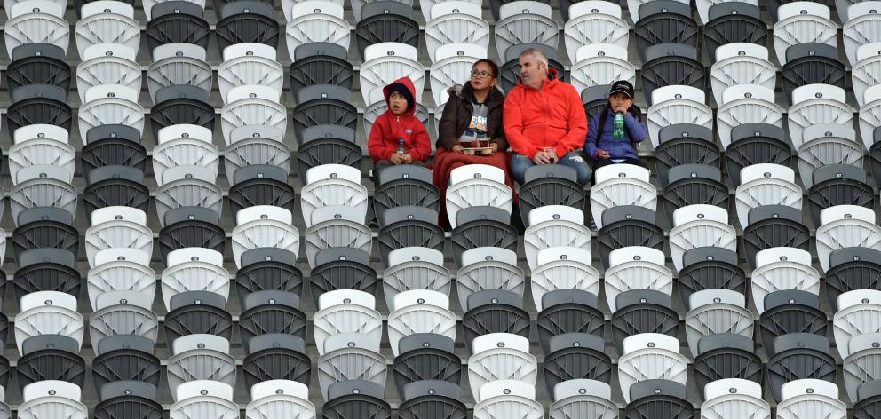 A small group of fans have plenty of seats from which to choose in the South Stand at Forsyth...