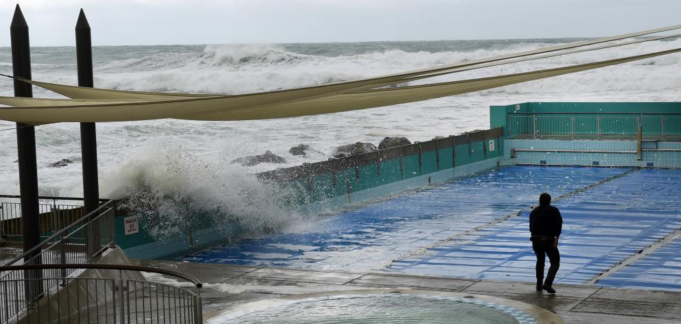 Waves crash over the rocks into the St Clair pool yesterday.