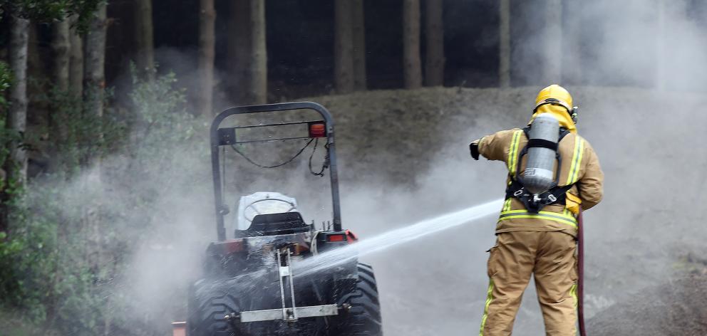 Firefighters extinguish yesterday’s  tractor blaze. Peter McIntosh