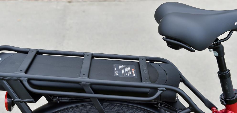 The battery snugly tucked under the carrier.