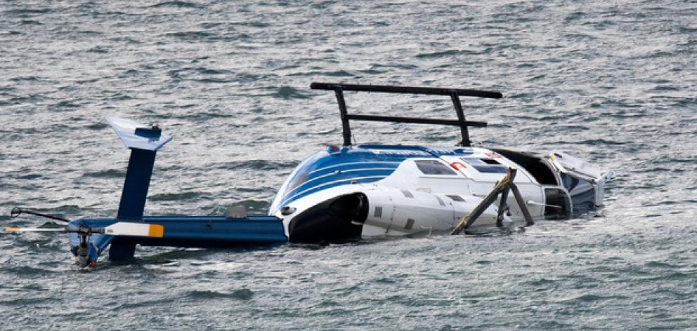 Pilot Rick Lucas clambered uninjured from the chopper after it crashed into Porirua Harbour in May last year (2017). Photo: NZ Herald