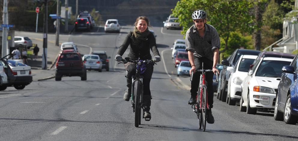 Critical Mass Dunedin participants Kitty Cresswell Riol and Geoff Wigley ride on Dundas St. PHOTO...