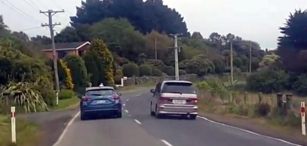 A rental car overtakes on a blind corner on the Otago Peninsula this week. Photo: George Block