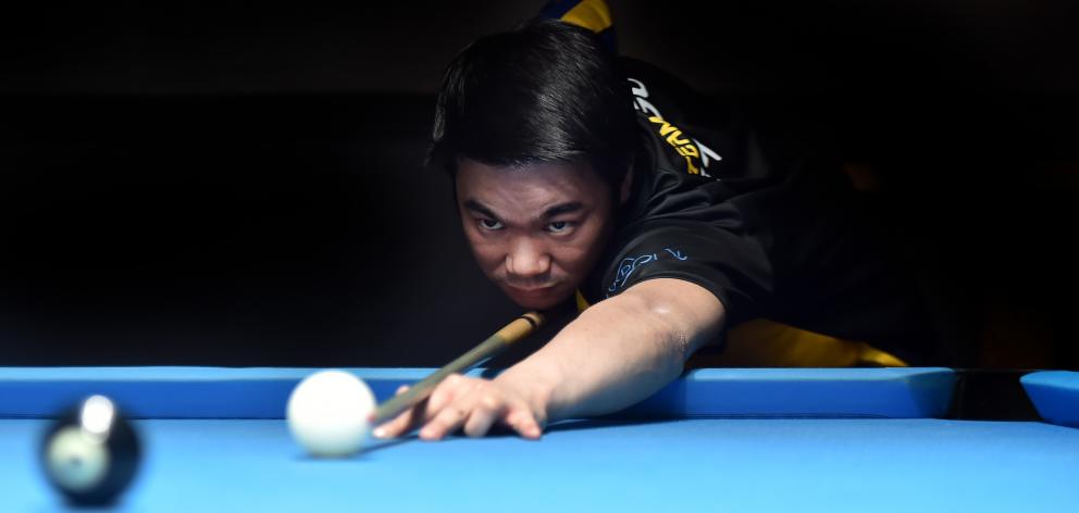 Dunedin 8-ball player Brendan Ng lines up the black during a practice session at Bowey’s Pool...