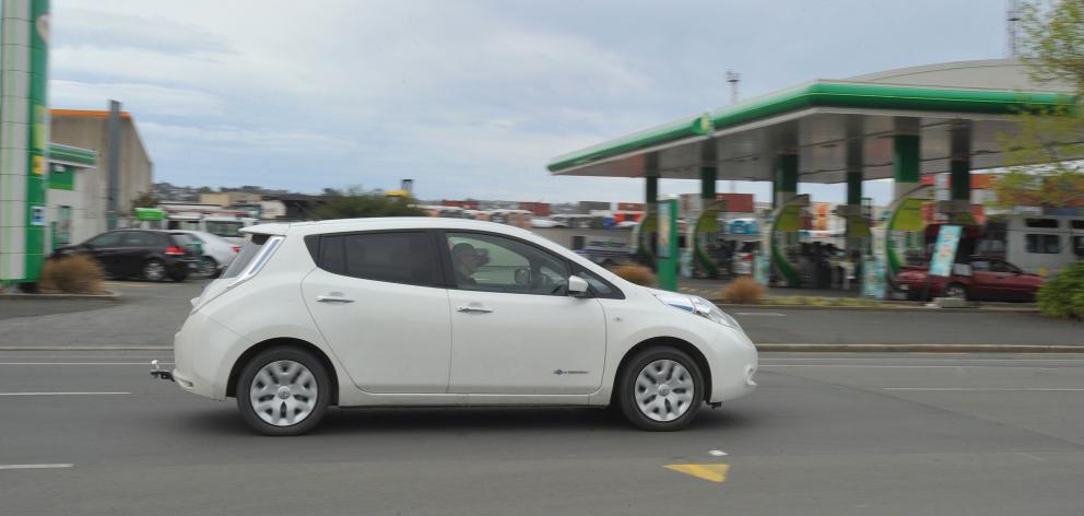 An electric vehicle passes the BP petrol station in Cumberland St yesterday. PHOTO: GREGOR...
