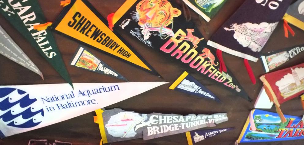 Some of many pennants that adorn a ceiling in Rick’s Garage.