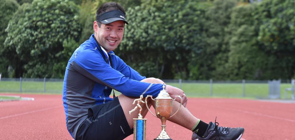 Greg Yee at the Caledonian Ground yesterday with the trophies he won at the national 24-hour...