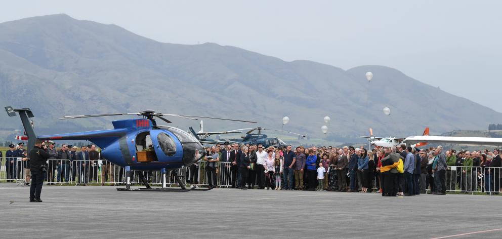 Balloons are released by family members before Paul Hondelink’s coffin is flown from his funeral...