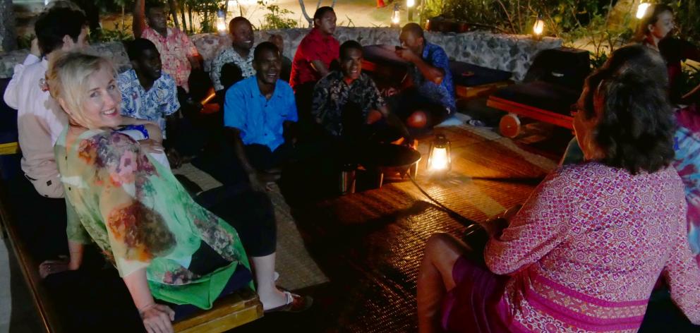 Guests and staff mingle at a kava ceremony at Tropica Island Resort, Fiji.



