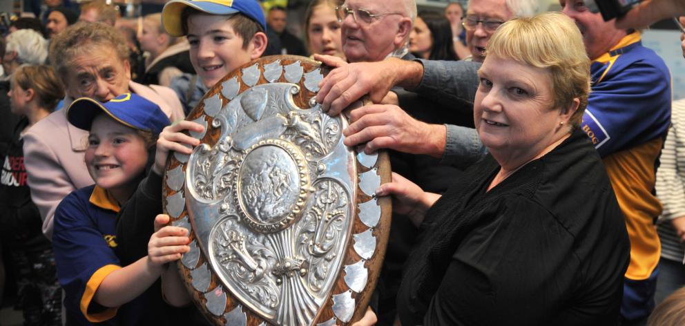 Fans clutch the shield at Dunedin Airport yesterday. Photos: Gregor Richardson