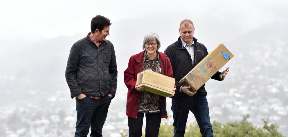 Predator Free Dunedin project manager Rhys Millar (left), Conservation Minister Eugenie Sage and Predator Free 2050 science strategy project manager Dan Thompkins place traps at Prospect Park in North Dunedin yesterday. Photo: Peter McIntosh