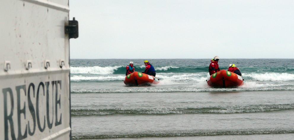 Members of the Otago Surf Life Saving SAR team, of Dunedin, end their day's search for two...