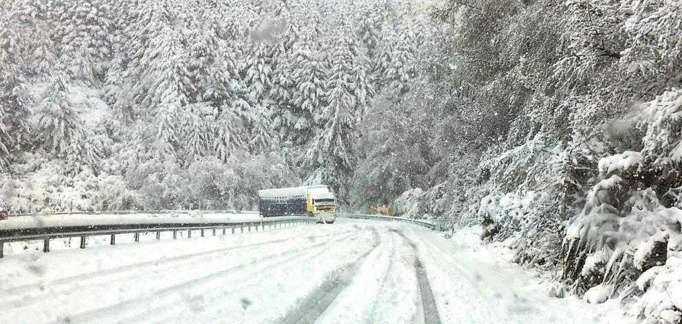 A truck edges towards Te Anau yesterday afternoon on snow-blanketed Blackmount-Redcliff Rd, near Monowai in western Southland. Photo: Southland District Council