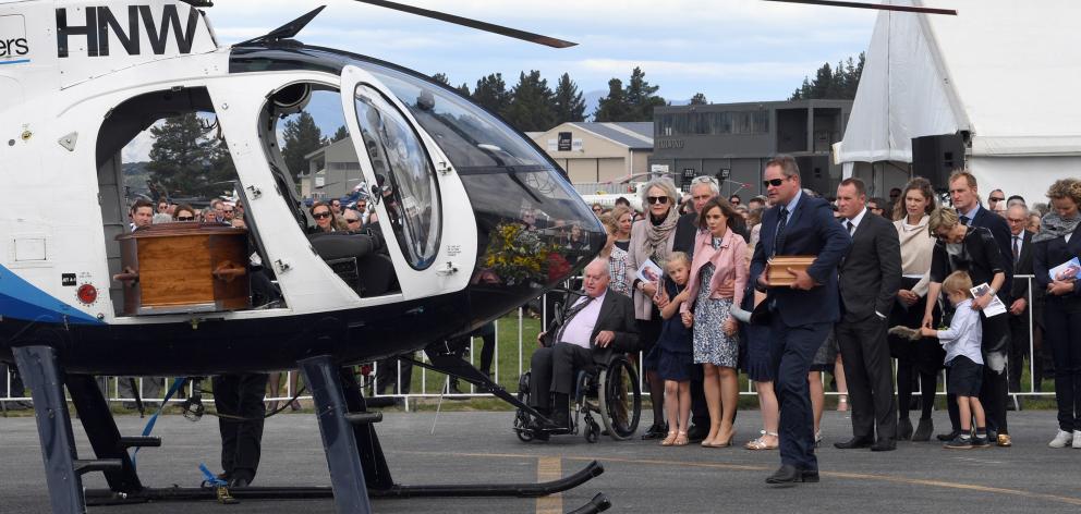 Toby Wallis carries the ashes of his brother Matt, to the helicopter with brother Nick’s coffin...
