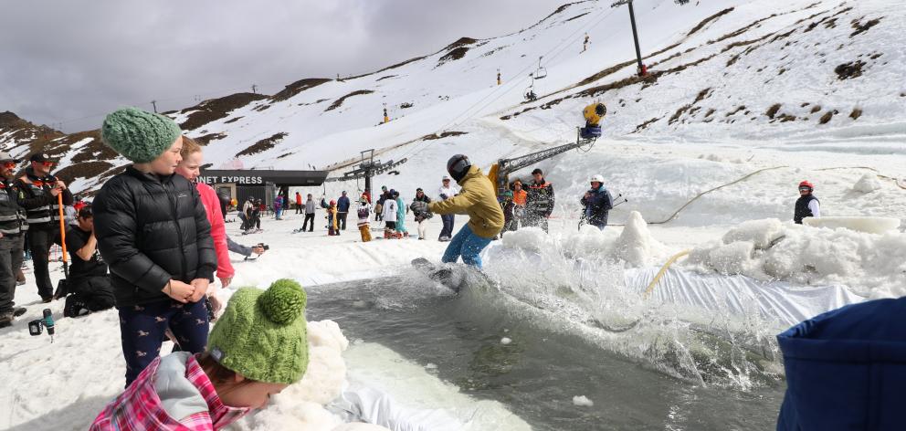 A snowboarder makes it across the water jump at Coronet Peak. Photo: Paul Taylor