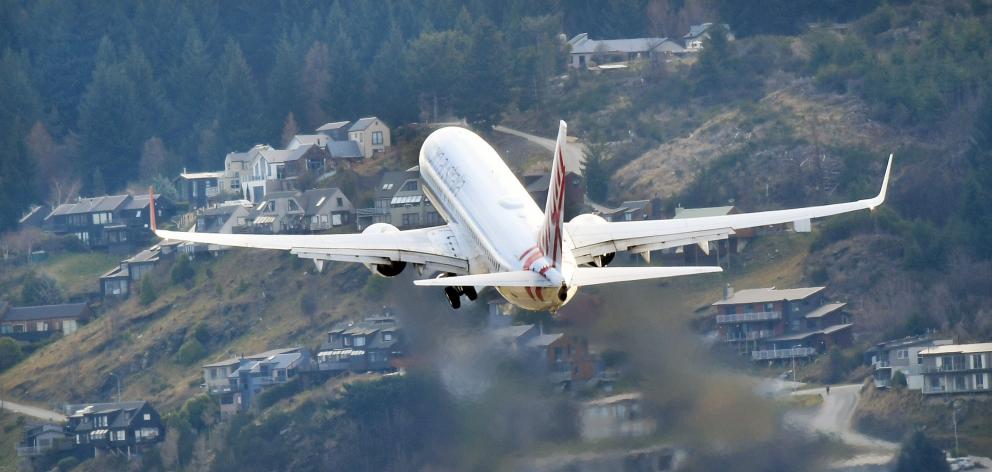 A Virgin Australia aircraft leaves Queenstown Airport over Frankton. Photo: Stephen Jaquiery