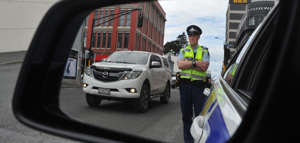  Sergeant Blair Dalton, of Dunedin, watches the traffic on Cumberland St yesterday. PHOTO: GREGOR...